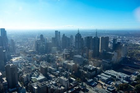 The skyline of downtown Melbourne, Australia, is captured from above, showcasing modern skyscrapers, urban infrastructure, and a winding river. The city's architecture and dense buildings reflect its dynamic metropolitan character and economic significanceの写真素材