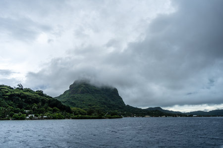 A stunning panoramic view of Bora Bora Island, with its lush mountains, crystal-clear water, and...