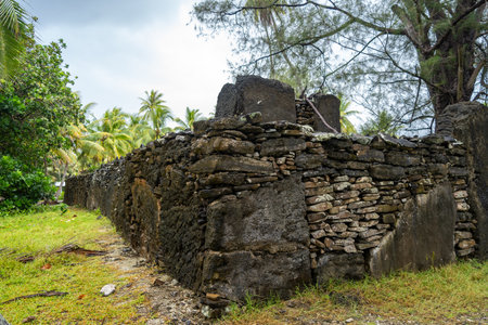 Marae Manunu, an ancient Polynesian sacred site on Huahine, stands among coconut trees and lush vegetation, preserving the islandâs spiritual and historical heritageの写真素材