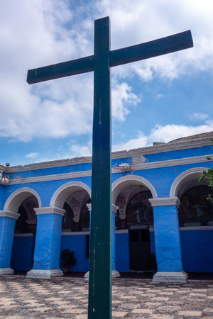 The Santa Catalina Monastery courtyard, with vibrant blue walls, trees, and flowers, offers a serene space for reflection and quiet momentsの写真素材