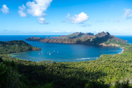 Anaho Bay in Nuku Hiva, French Polynesia, offers turquoise waters, lush green mountains, and a pristine beach, creating a breathtaking tropical paradise in the Marquesas Islandsの写真素材