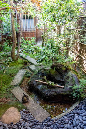 Peaceful garden surrounding a traditional wooden house in Nagamachi District, Kanazawa, featuring...