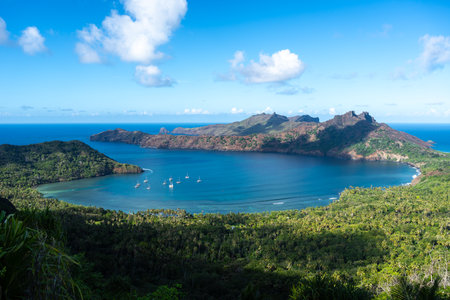 Anaho Bay in Nuku Hiva, French Polynesia, offers turquoise waters, lush green mountains, and a pristine beach, creating a breathtaking tropical paradise in the Marquesas Islandsの写真素材