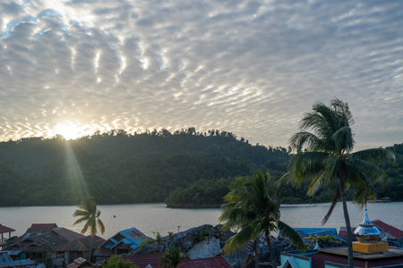 The mosque of Pulau Papan stands among the fishermenâs houses, illuminated by the warm sunset light over Malenge Island in Sulawesi, Indonesiaの写真素材