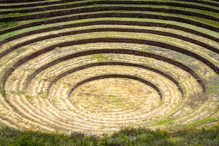 The Inca site of Moray in the Sacred Valley, Peru, features concentric terraces used for ancient agricultural experiments, showcasing advanced engineering and adaptation to different microclimatesの写真素材