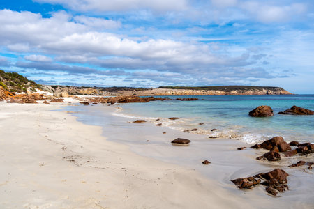 Stokes Bay Beach on Kangaroo Island, Australia, has white sand, turquoise water, and rocky formations. The secluded beach is surrounded by cliffs and natural vegetation, creating a peaceful and picturesque coastal landscapeの写真素材