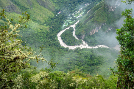 Overlooking the lush valley near Machu Picchu, with a winding river cutting through the dense forest...