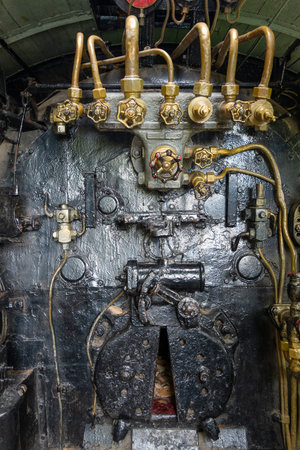 Steam locomotive C59161 stands on display in a peaceful Hiroshima park, offering a close look at its...