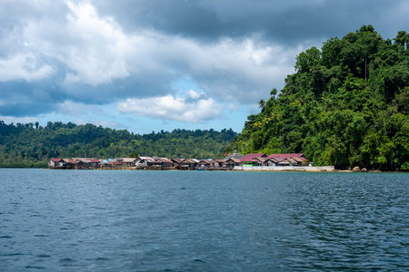 Traditional Bajo houses on wooden stilts above turquoise water in a remote coastal village of the...