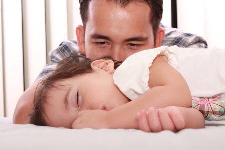 Father watch his beautiful baby while she sleepsの写真素材