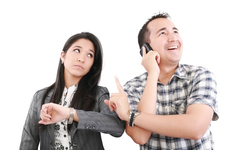 give me one minute, caucasian mid adult person talking on cellphone telling to wait one minute to his coupleの写真素材