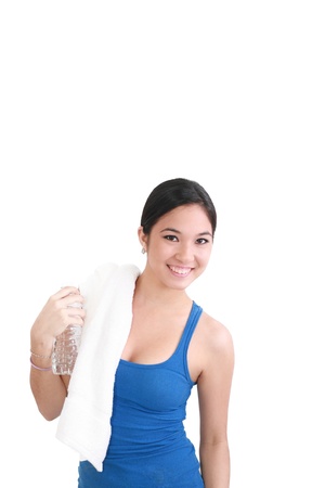 portrait of woman in fitness attire holding water bottle and smilingの写真素材