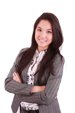 portrait of a happy young business woman standing with folded hand against white background の写真素材