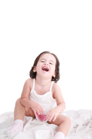 laughing little girl on her bedの写真素材
