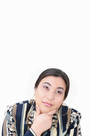 thoughtful woman looking up isolated over white backgroundの写真素材