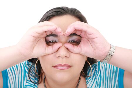 Young woman looking through imaginary binocular の写真素材