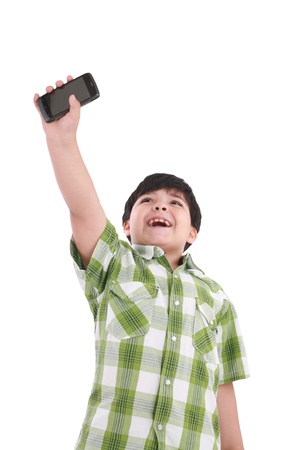 boy holding up cellular phone and smilingの写真素材