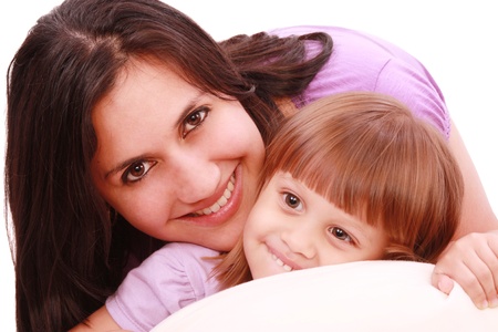 Mother and daughter posing happily in bedの写真素材