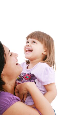 Mother and daughter smiling isolated over a white background. Focus in the little girl.の写真素材