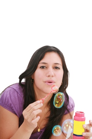 Young woman portrait making soap bubbles. の写真素材
