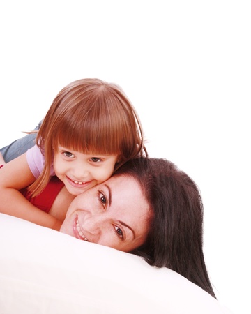 Young Mother and daugther embracing on bed の写真素材