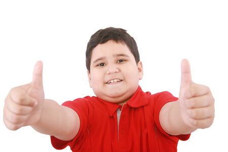 Thumbs up shown by a happy young boy の写真素材