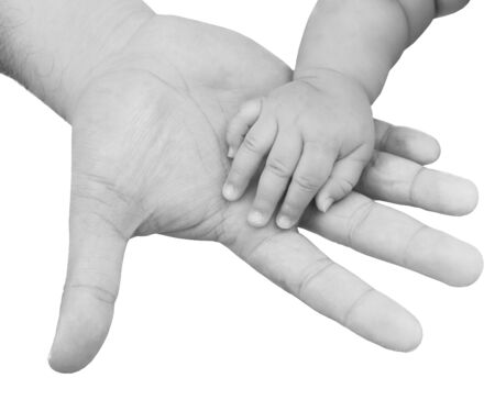 adult hand holding a baby hand closeup, black and white の写真素材