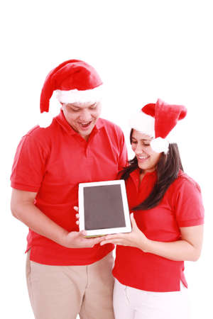 Couple enjoying their new touchpad on christmasの写真素材