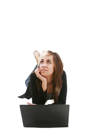 Girl with laptop on floor thinking about somethingの写真素材