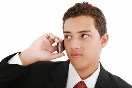 Close-up of attractive young businessman on cellphone. Nineteen years old.の写真素材