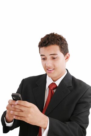 A handsome young business man texting on his phoneの写真素材