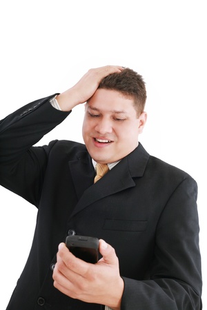 A young handsome businessman looking worried his cellphone over whiteの写真素材