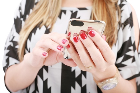 Close shot of woman hand holding a mobile phone typing a sms 
の写真素材