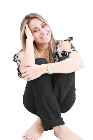 Beautiful girl sitting in the floor, isolated on whiteの写真素材