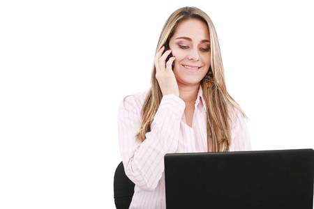 Young smiling business woman with laptop and cellular の写真素材
