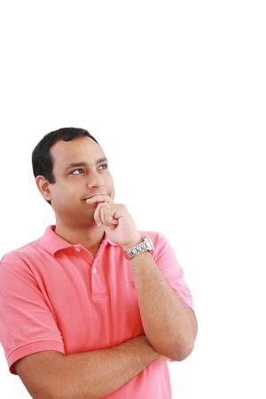 handsome hispanic man looking upwards at copyspace thinking 
の写真素材