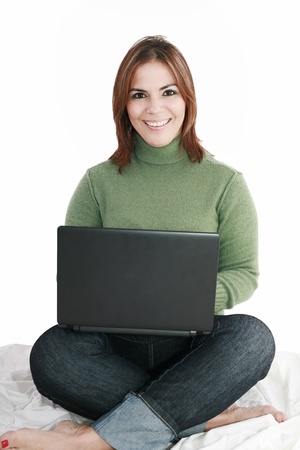 Woman student sitting with laptop isolated on white backgroundの写真素材