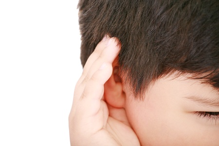 A little boy trying to hearing the sound around him - What did you say  の写真素材