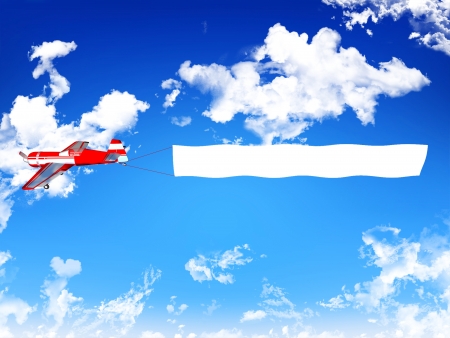 Biplane aircraft pulling advertisement banner の写真素材