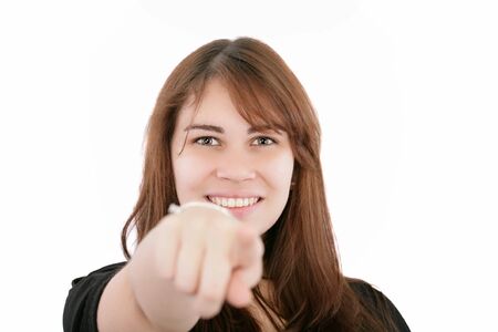 Portrait of a young smiling businesswoman pointing at you  Isolated on white  Focus on womanの写真素材