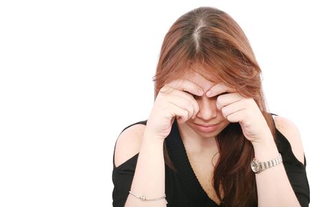 Young business woman looking worried at desk on white backgroundの写真素材