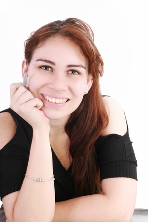 Portrait of a pretty young businesswoman at the office desk holding a pen against white background の写真素材