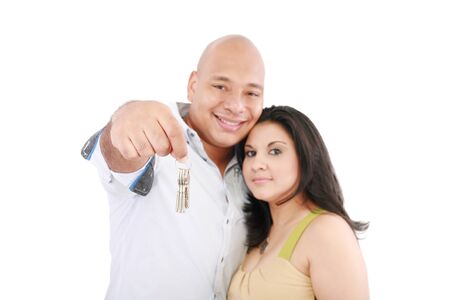 Young smiling couple holding keys of their new house の写真素材