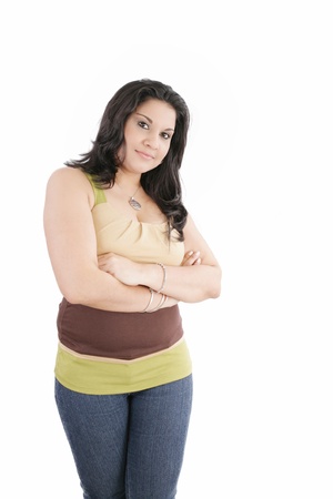 Portrait of an attractive young woman standing with her hand folded against white backgroundの写真素材