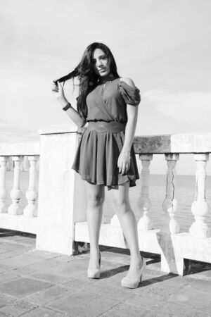 Young woman standing. Black and white concept. の写真素材