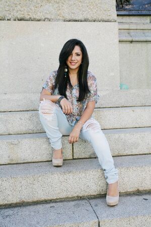 Beautiful girl sitting on stairs の写真素材