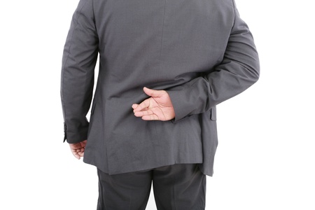 Liar businessman with crossed fingers at back. Isolated on white background の写真素材