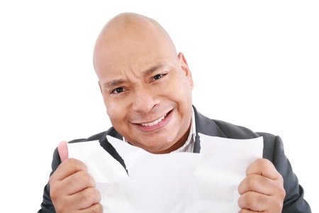 Business man looking angry tearing the stock pages 