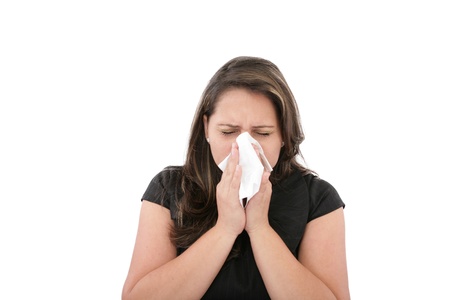 A woman with a cold or allergy wiping or blowing her nose. の写真素材