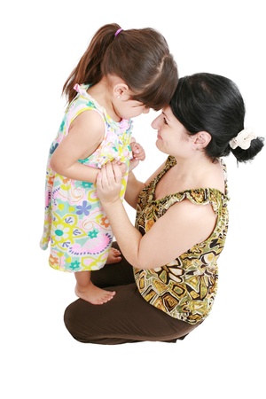 Beautiful latin mother and daughter smiling with love at each other の写真素材